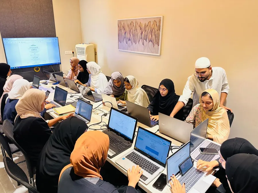 Trainer guiding students during a laptop class at Wordcraft Institute