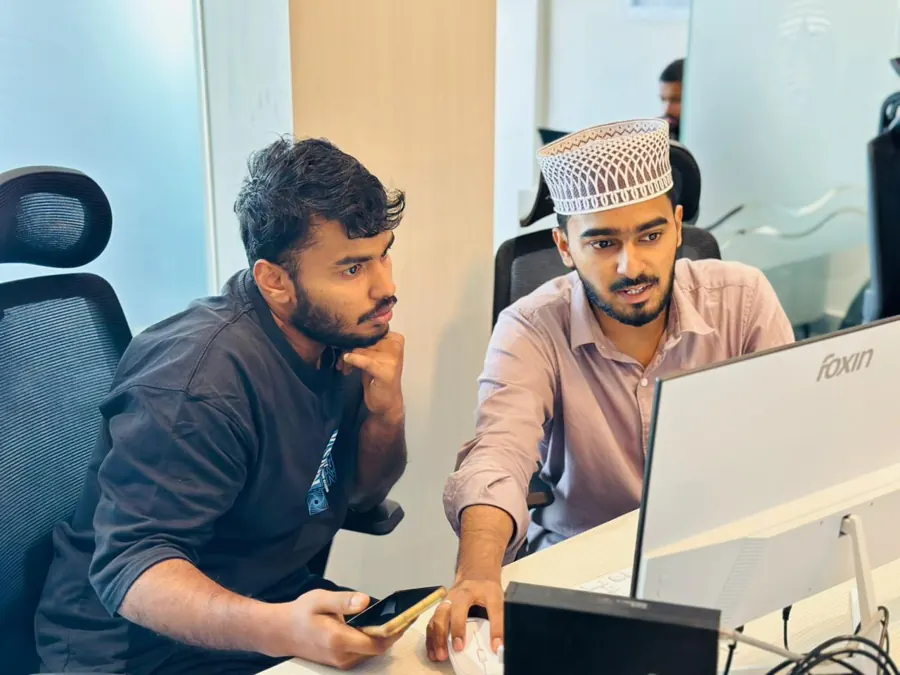 Mentor helping a student at a computer at Wordcraft Institute, Calicut